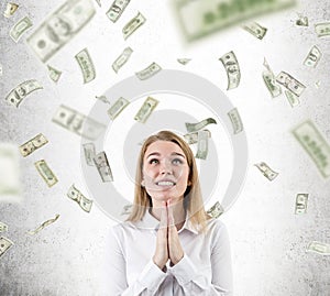 Woman praying for the dollar rain not to stop