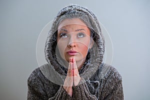 Woman praying with frost on her face