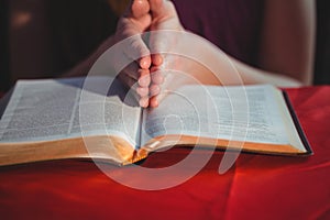 Woman praying with her bible