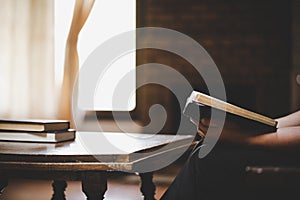 Woman praying on holy bible in the morning