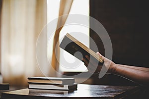 Woman praying on holy bible in the morning