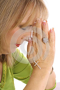 Woman praying with rhinestone cross upclose photo