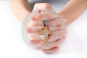 Woman praying with Rosary catholic cross photo