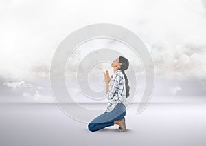 Woman praying under clouds