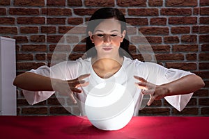 Woman Predicting Future With Crystal Ball