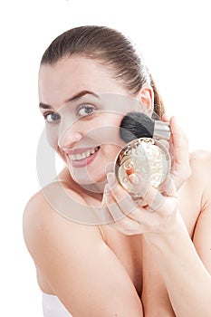 Woman preens with a brush for blush.