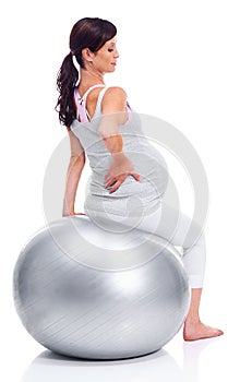 Woman, pregnant and mother with ball for fitness, exercise and training in pregnancy on white background. Female person