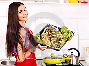 Woman prepare fish in oven.