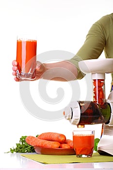 Woman prepare Juice extractor and carrot