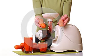 Woman prepare Juice extractor and carrot