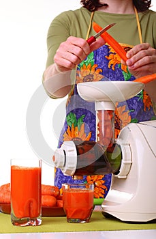 Woman prepare Juice extractor and carrot