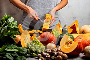 Woman prepare squash for cooking pumpkin dish. Close-up.