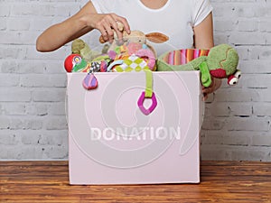 Woman prepare to donate toys in charity shop