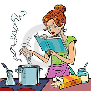 A woman prepares food with a cookbook in her hands