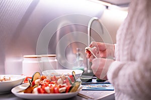 Woman prepares meat and vegetable skewers