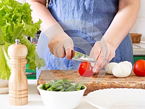 A woman prepares a vegetable salad in the kitchen. Healthy Food. The Concept Of A Diet. Healthy Lifestyle. I Cook At