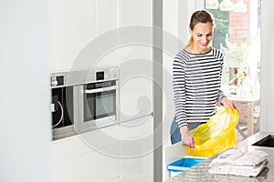 Woman preparing bin for segregation