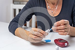 woman is preparing blood lamcets for measuring