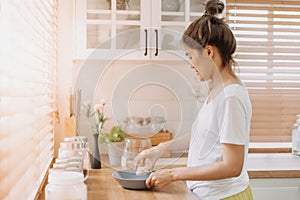 Woman preparing breakfast in the kitchen in the morning.