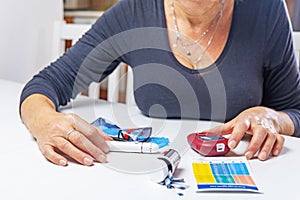 Woman is preparing device for measuring blood sugar