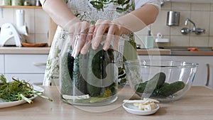 Woman is preparing homemade sour cucumbers