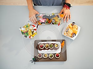 Woman preparing horribly halloween treats for party. Closeup