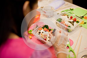 Woman preparing a japanese bento