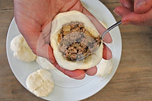 Woman preparing Kubbeh matfuniya Levantine dish