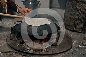 Woman preparing or making borek or bread dough on fire