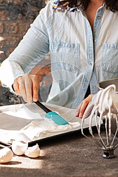 Woman preparing meringue for the cake