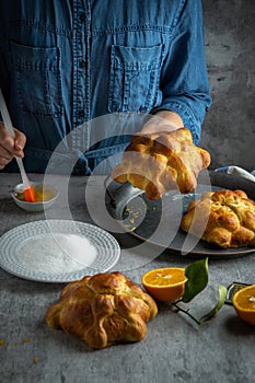 Woman preparing Pan de muertos bread of the dead for Mexican day of the dead