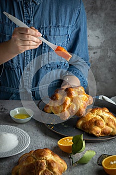 Woman preparing Pan de muertos bread of the dead for Mexican day of the dead