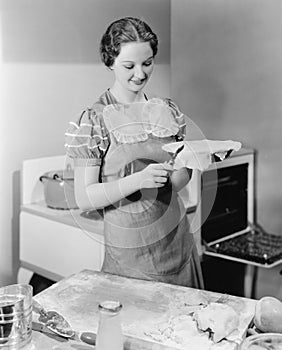 Woman preparing a pie in the kitchen photo