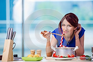 The woman preparing soup in the kitchen