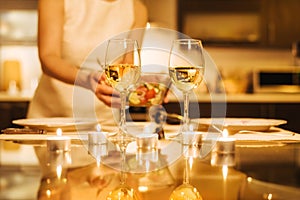 Woman preparing supper for two persons.