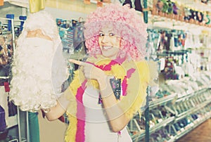 Woman preparing to fest and choosing clown wig