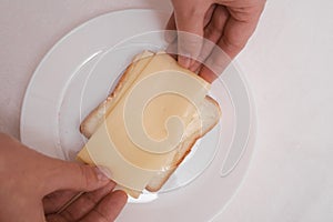woman preparing toast with cheese close up