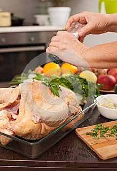 Woman preparing a Turkey for roasting in the kitchen