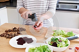 Woman preparing vegetable salad in her kitchen. Healthy Food. Diet.Healthy lifestyle concept.Vegan Salad.Cooking At Home