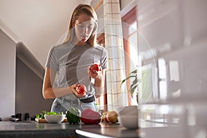 Woman preparing vegetarian dinner in a kitchen