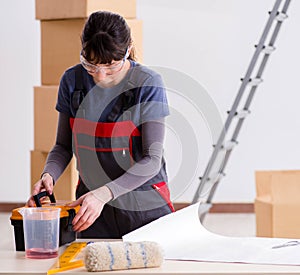 Woman preparing for wallpaper work