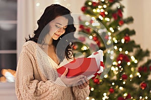 Woman With Present in the Gift Box Near Christmas Tree at Home