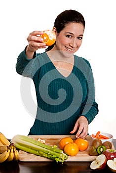 Woman presenting peeled ornage fruit