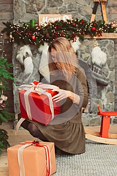 Woman with presents in Christmas interior