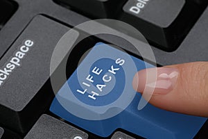 Woman pressing blue button with words Life Hacks on computer keyboard, closeup