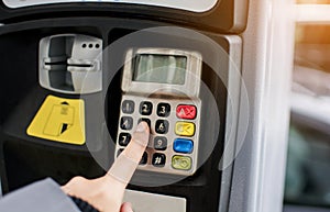 Woman pressing the button to paying car parking meter