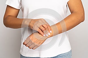 Woman pressing fingers on wrist check pulse. Female touch arm, measure heart beat or blood pressure