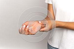 Woman pressing fingers on wrist check pulse. Female touch arm, measure heart beat or blood pressure
