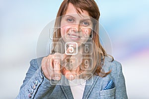 Woman pressing numerical button on virtual touch screen