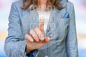 Woman pressing numerical button on virtual touch screen